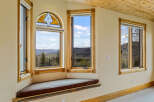 This stunning property boasts a unique architectural design with expansive windows that frame breathtaking mountain views.