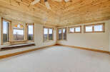 This stunning room boasts a unique wooden ceiling and ample natural light, creating a warm and inviting atmosphere.