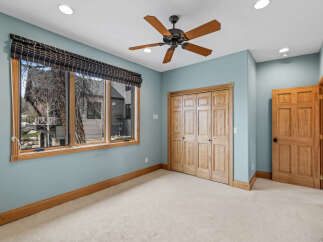 This inviting bedroom features a neutral color palette and ample natural light, creating a serene atmosphere.
