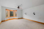 This spacious room features a large bay window, allowing natural light to flood the space.
