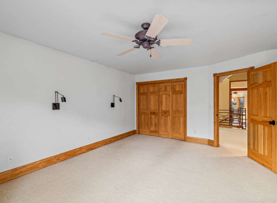 This spacious room features a neutral color palette, creating a bright and inviting atmosphere.