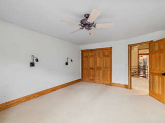 This spacious room features a neutral color palette, creating a bright and inviting atmosphere.