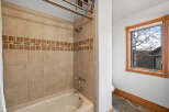 This beautiful bathroom features a tiled shower and tub, perfect for a relaxing soak.
