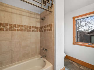 This beautiful bathroom features a tiled shower and tub, perfect for a relaxing soak.