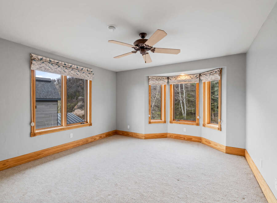This stunning room boasts an abundance of natural light, thanks to its expansive windows.