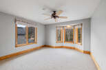 This stunning room boasts an abundance of natural light, thanks to its expansive windows.