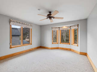 This stunning room boasts an abundance of natural light, thanks to its expansive windows.