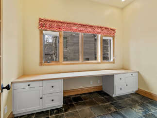This inviting home office space features a built-in desk with ample storage, perfect for productivity.