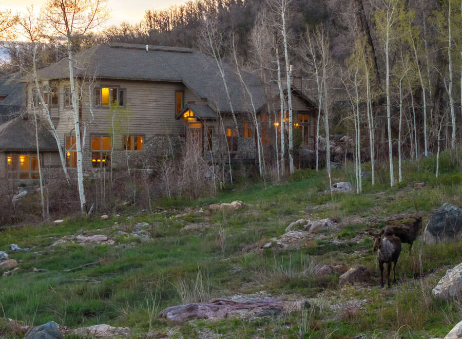 Nestled in a serene natural setting, this stunning property boasts a beautiful wooden house with multiple windows that offer breathtaking views.