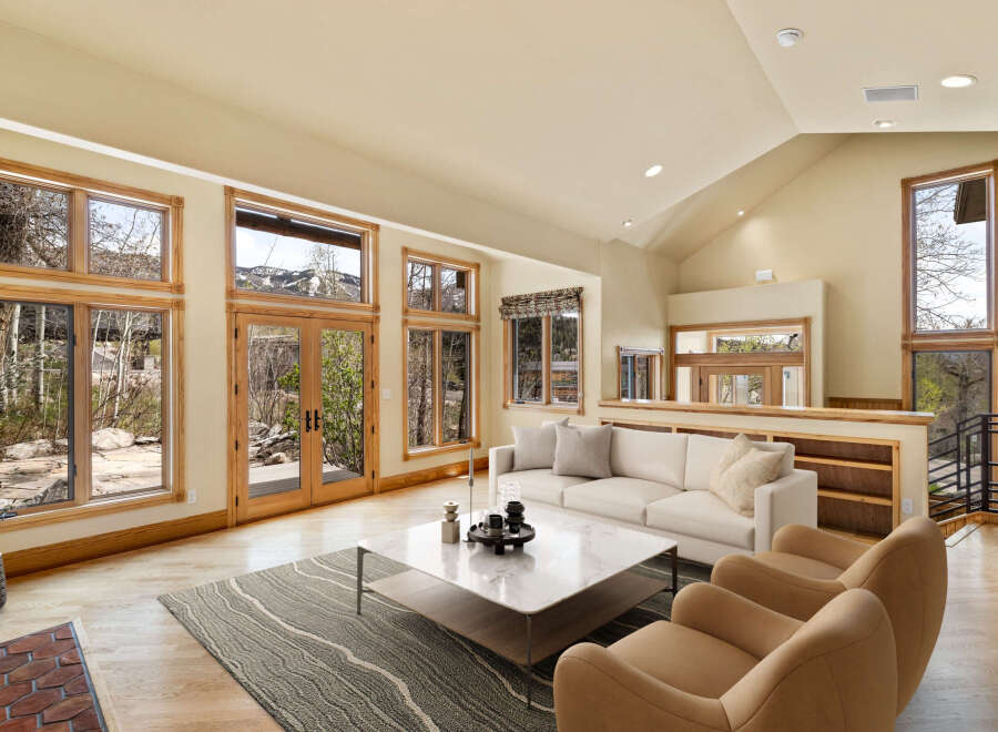 This stunning living room boasts an open and airy design, perfect for entertaining or relaxing.