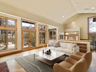 This stunning living room boasts an open and airy design, perfect for entertaining or relaxing.