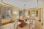 This elegant dining room features a stunning wooden table and stylish white chairs, perfect for hosting memorable gatherings.
