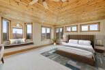 This stunning bedroom boasts a unique architectural design with a vaulted, wood-paneled ceiling that adds warmth and character.