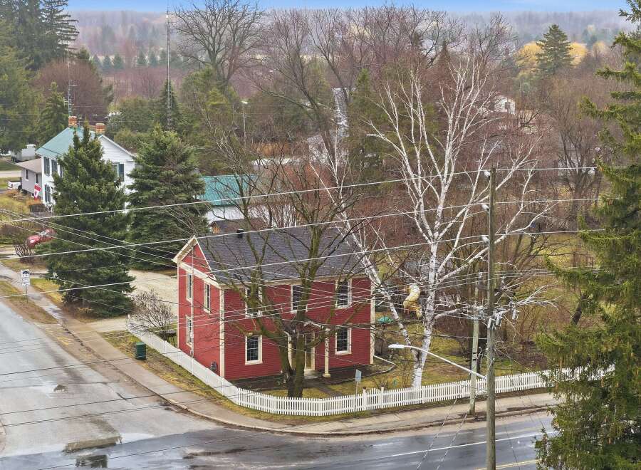 This charming red house, nestled in a serene neighborhood, offers a blend of classic architecture and modern comfort.