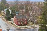 This charming red house, nestled in a serene neighborhood, offers a blend of classic architecture and modern comfort.