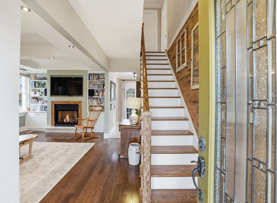 Step into luxury with this stunning property featuring a grand staircase and inviting fireplace.