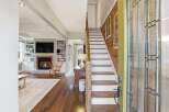 Step into luxury with this stunning property featuring a grand staircase and inviting fireplace.