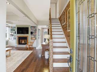 Step into luxury with this stunning property featuring a grand staircase and inviting fireplace.