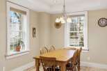 This charming dining room features a warm, inviting atmosphere, perfect for family meals and gatherings.