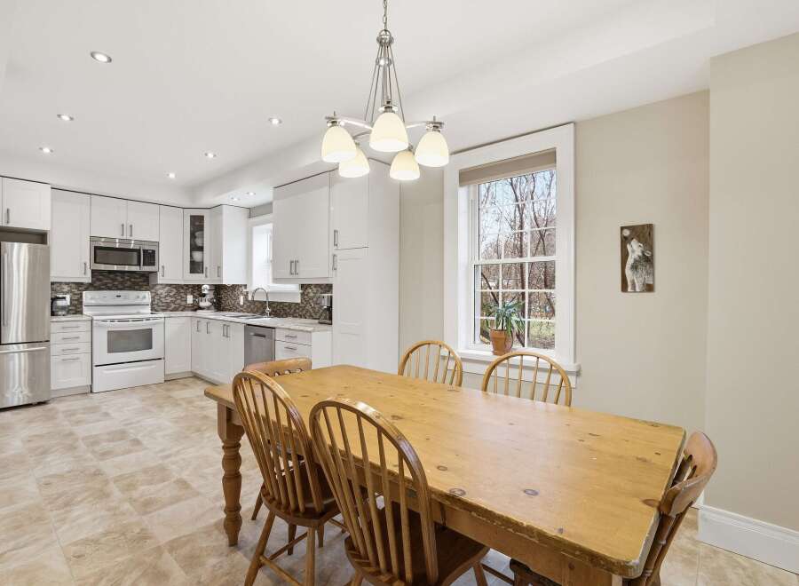 This bright and airy kitchen and dining area offers a perfect blend of functionality and style.