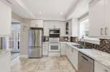 This stunning kitchen boasts a bright and airy design, perfect for culinary enthusiasts.