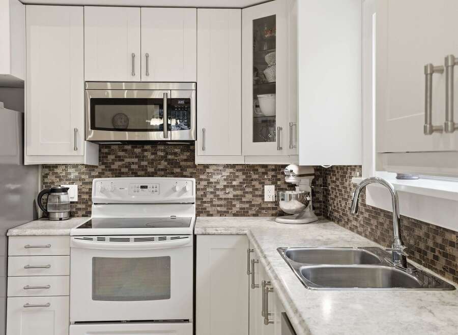This stunning kitchen boasts modern appliances and ample storage space, perfect for culinary enthusiasts.
