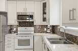 This stunning kitchen boasts modern appliances and ample storage space, perfect for culinary enthusiasts.