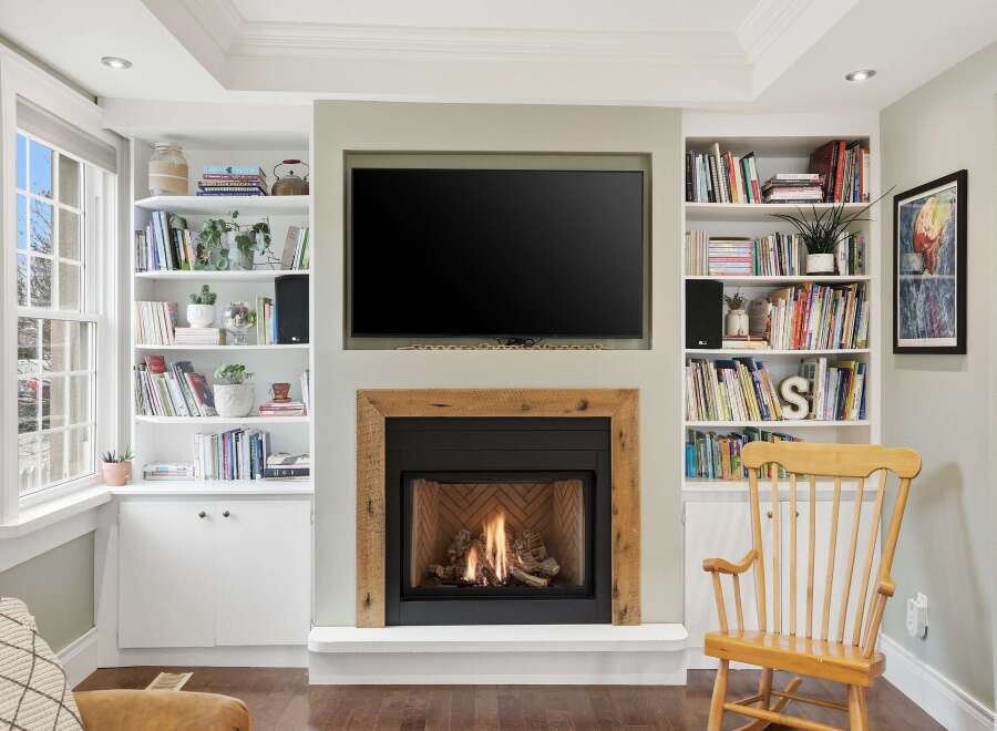 This stunning living space features a cozy fireplace with a rustic wooden mantel, perfect for creating a warm and inviting atmosphere.