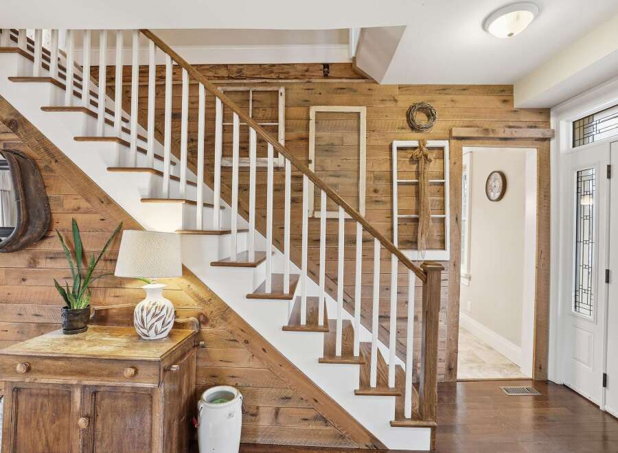 Step into rustic elegance with this stunning home featuring a beautifully crafted staircase.