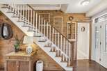 Step into rustic elegance with this stunning home featuring a beautifully crafted staircase.