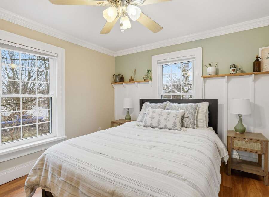 This charming bedroom offers a serene retreat with its inviting ambiance and stylish decor.