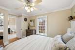 This cozy bedroom features a comfortable bed with stylish pillows and a ceiling fan for added comfort.