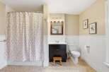 This charming bathroom features a stylish shower curtain with a floral pattern, adding a touch of elegance to the space.