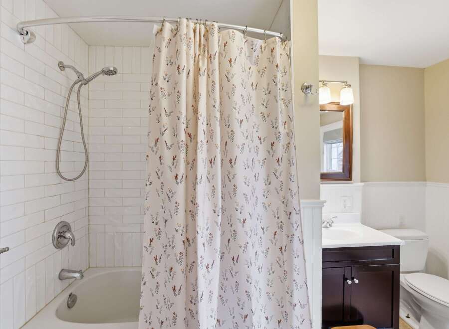 This charming bathroom features a bright and airy design, perfect for relaxation.