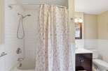 This charming bathroom features a bright and airy design, perfect for relaxation.