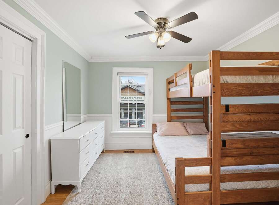 This charming bedroom features a cozy bunk bed, perfect for accommodating guests or family members.