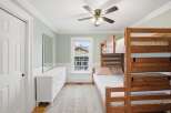 This charming bedroom features a cozy bunk bed, perfect for accommodating guests or family members.
