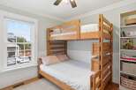 This charming bedroom features a sturdy wooden bunk bed, perfect for kids or guests.