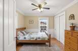 This charming bedroom features a cozy wooden bed frame and a colorful quilt, creating a warm and inviting atmosphere.