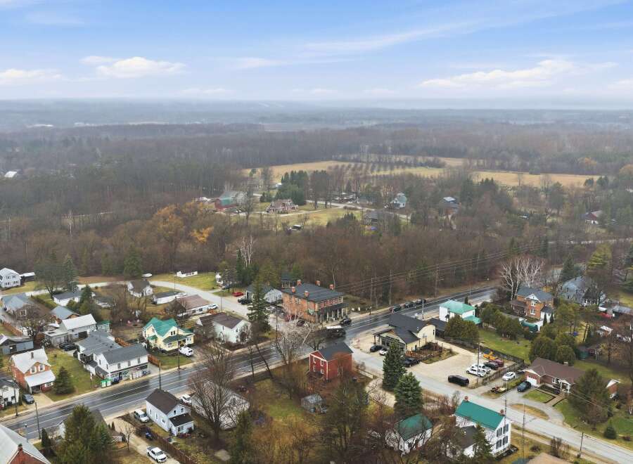 Explore this charming townscape, featuring a variety of homes and buildings nestled amidst lush greenery.