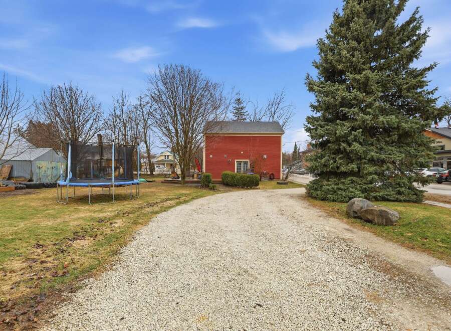 This charming property features a spacious yard with a trampoline, perfect for outdoor fun.