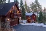 This stunning mountain home boasts a rustic charm with its wooden exterior and stone accents.