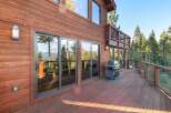 Enjoy breathtaking views from this stunning property featuring a spacious deck and a modern grill, perfect for outdoor entertaining.