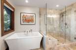 This luxurious bathroom features a modern freestanding bathtub, perfect for relaxing after a long day.