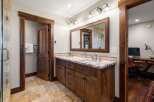 This stunning bathroom boasts a rustic charm with its wooden cabinetry and trim, creating a warm and inviting atmosphere.