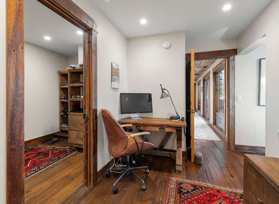 Step into this inviting home office, featuring a stylish desk and comfortable chair.