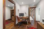 Step into this inviting home office, featuring a stylish desk and comfortable chair.
