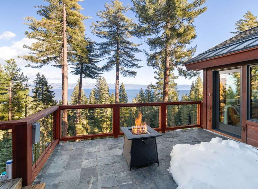 Enjoy breathtaking views from this stunning property, featuring a cozy outdoor fire pit perfect for chilly evenings.