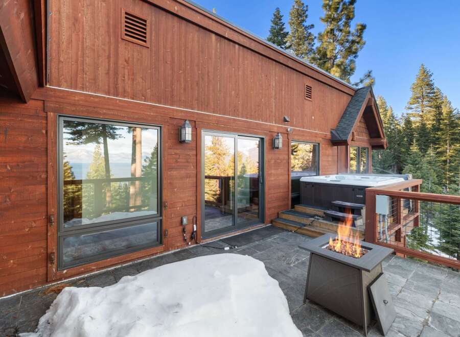 Experience luxury living in this stunning property featuring a private hot tub and a cozy outdoor fireplace, perfect for relaxing evenings.