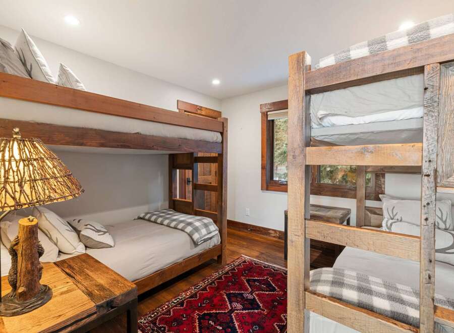 This charming bedroom features rustic bunk beds, perfect for accommodating guests or family.